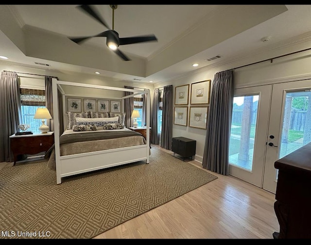 bedroom featuring wood finished floors, access to exterior, visible vents, crown molding, and ceiling fan