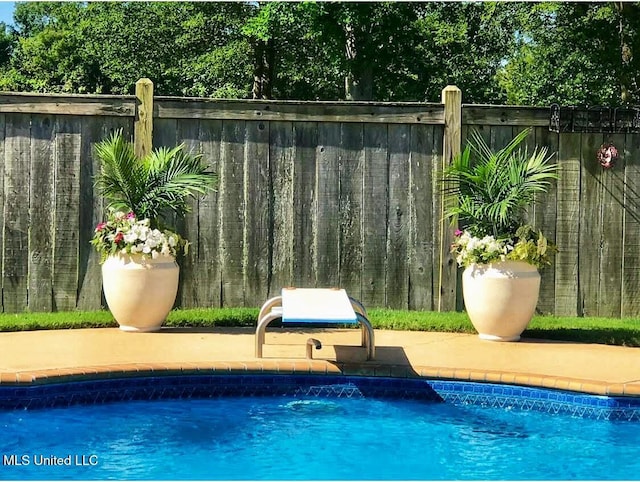 view of swimming pool featuring a fenced in pool and fence
