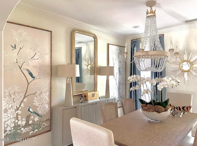 dining room featuring a notable chandelier, crown molding, and visible vents