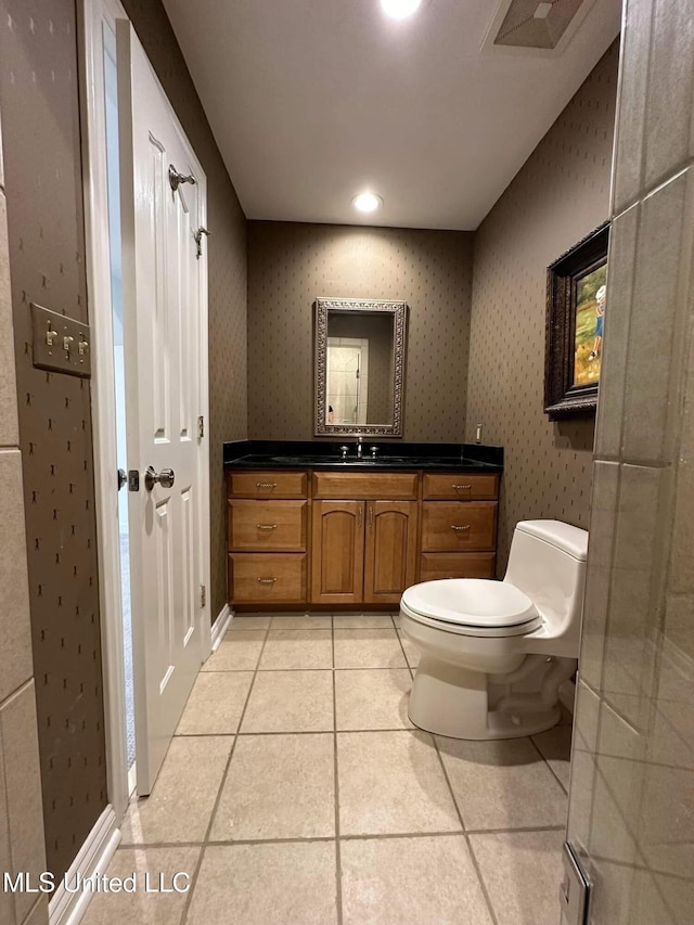 bathroom featuring tile patterned floors, vanity, and toilet