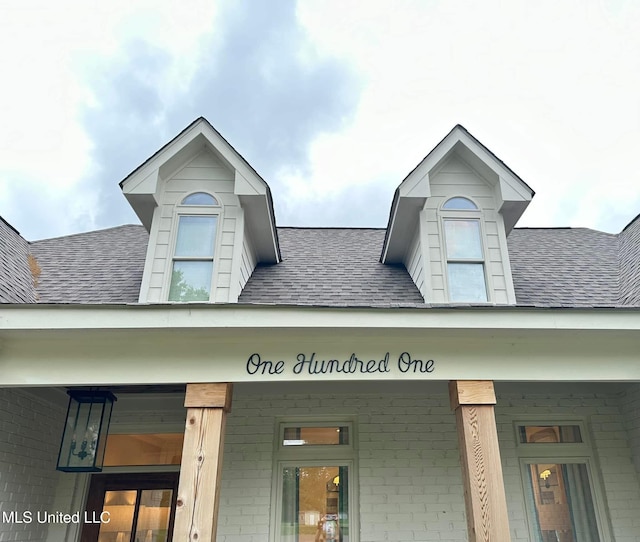 exterior details featuring a shingled roof
