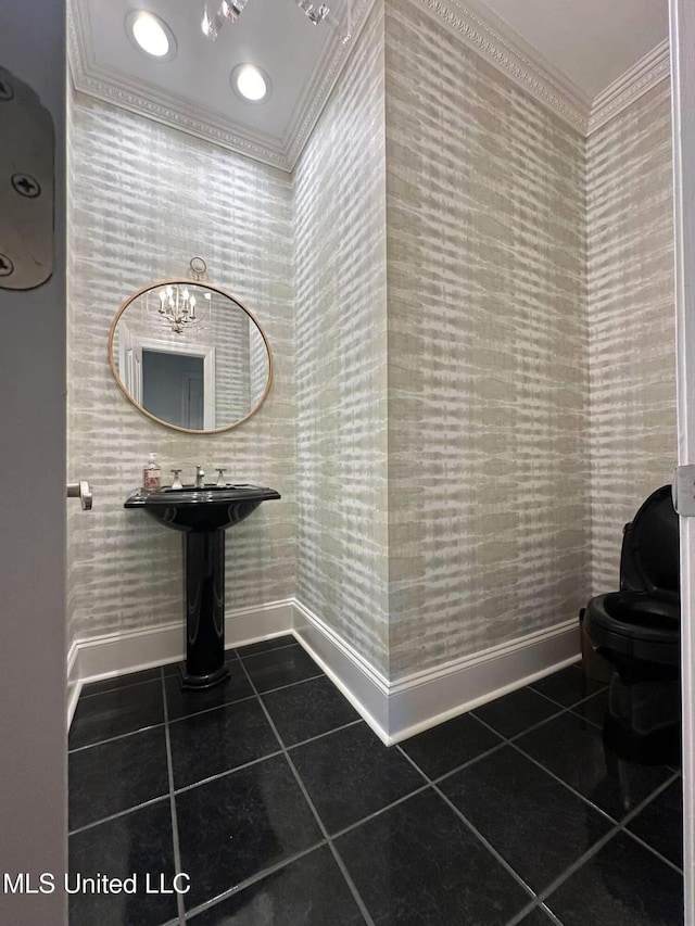 bathroom with tile patterned floors, toilet, baseboards, wallpapered walls, and crown molding