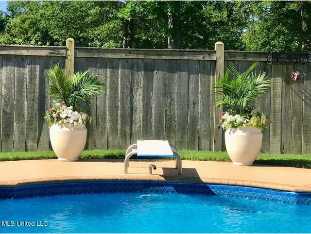 view of pool with fence