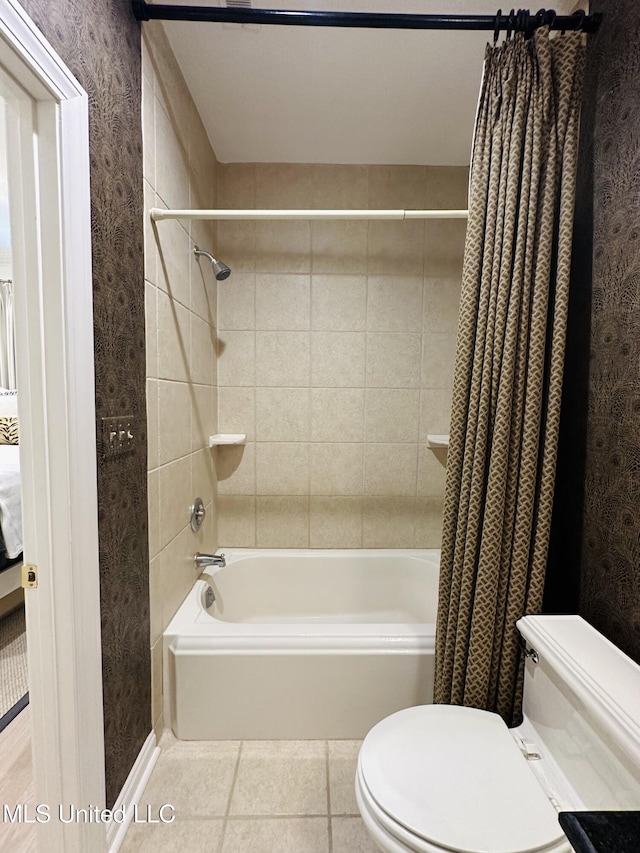 full bathroom with shower / tub combo with curtain, tile patterned floors, and toilet