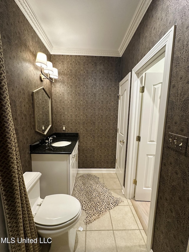 bathroom with tile patterned flooring, vanity, ornamental molding, and toilet