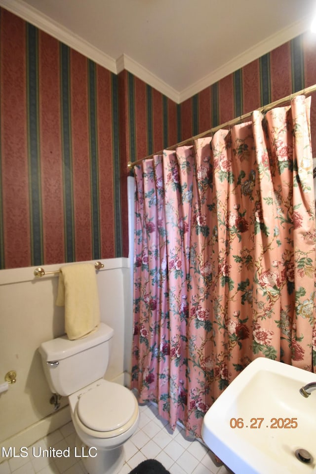 1211 River Rd, Greenwood, MS 38930 - bathroom with tile patterned floors, a shower with shower curtain, ornamental molding, and a wainscoted wall