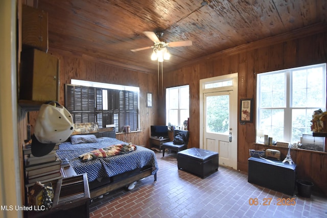 1211 River Rd, Greenwood, MS 38930 - bedroom featuring wood ceiling, wood walls, and brick patterned floors