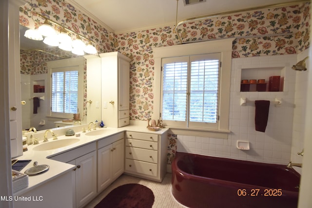 1211 River Rd, Greenwood, MS 38930 - bathroom featuring crown molding, a tub to relax in, wallpapered walls, double vanity, and tile walls