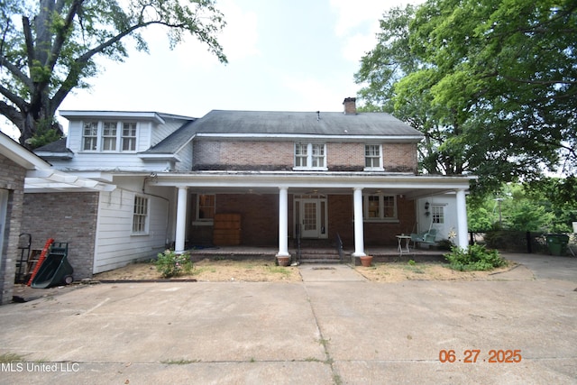1211 River Rd, Greenwood, MS 38930 - rear view of house with brick siding, a chimney, and covered porch