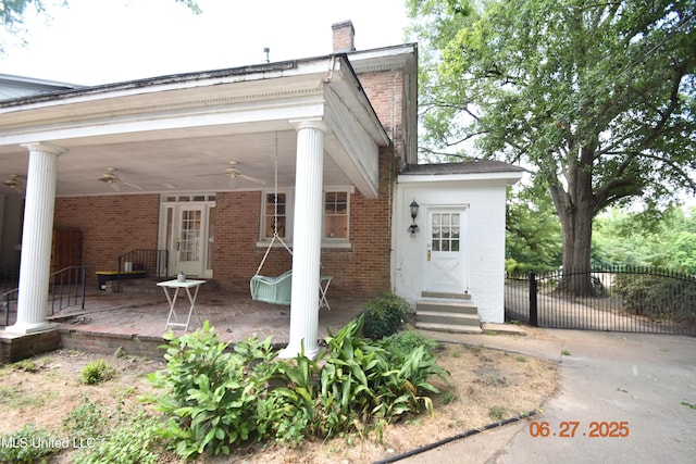 1211 River Rd, Greenwood, MS 38930 - back of property featuring brick siding, a ceiling fan, a chimney, and entry steps
