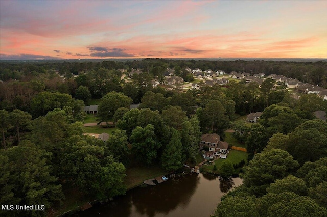 aerial view at dusk with a water view