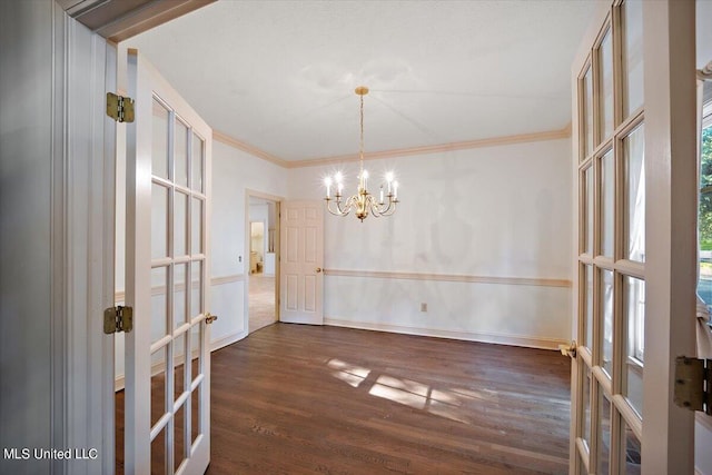 unfurnished dining area featuring ornamental molding, french doors, and dark hardwood / wood-style floors