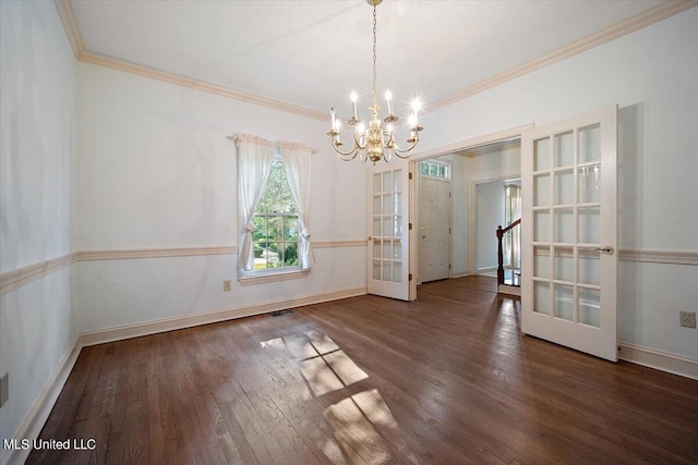 unfurnished dining area featuring ornamental molding, french doors, an inviting chandelier, and dark hardwood / wood-style flooring