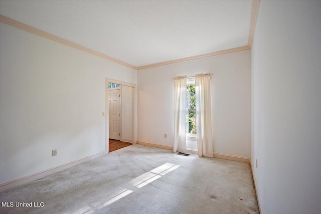 carpeted spare room featuring ornamental molding