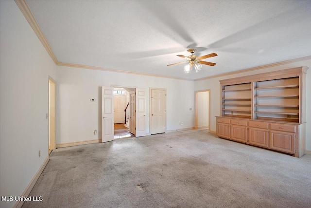 interior space featuring ornamental molding, a textured ceiling, light colored carpet, and ceiling fan