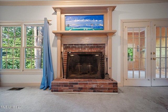 interior details with crown molding, carpet, and a fireplace