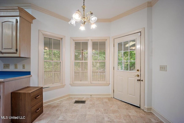 doorway featuring crown molding, an inviting chandelier, and plenty of natural light