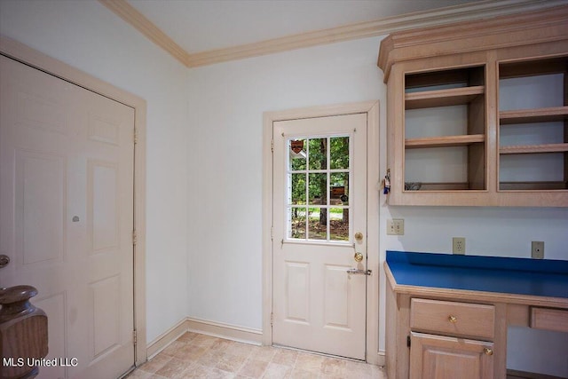 doorway to outside featuring built in desk and ornamental molding