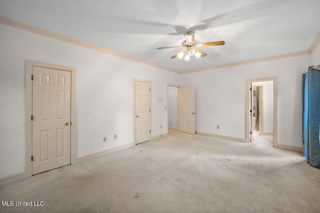 unfurnished bedroom with crown molding, light colored carpet, and ceiling fan