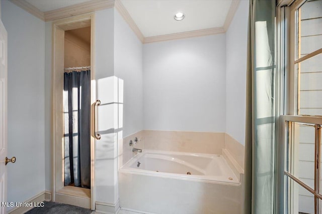 bathroom with ornamental molding and shower with separate bathtub