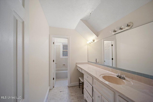 bathroom featuring vanity, a textured ceiling, and tile patterned floors