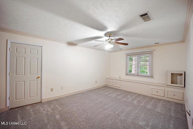 carpeted spare room featuring crown molding, a textured ceiling, and ceiling fan