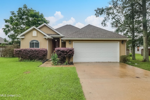 view of front of property with a front yard and a garage