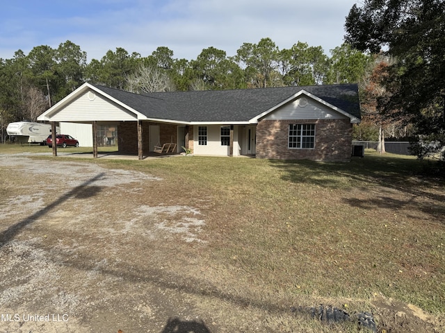 ranch-style house featuring a front yard and a carport