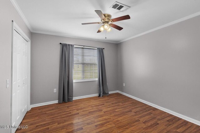 1144 Little Big Mound Rd, Bentonia, MS 39040 - unfurnished bedroom with crown molding, baseboards, visible vents, a closet, and wood finished floors
