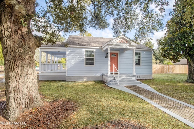 view of front of house with crawl space, roof with shingles, a front lawn, and fence