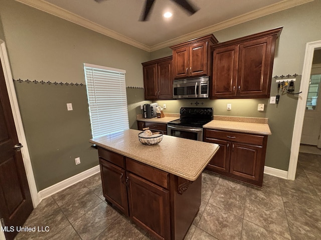 706 Anchor Lake Rd, Carriere, MS 39426 - kitchen with stainless steel microwave, electric range, light countertops, crown molding, and a center island
