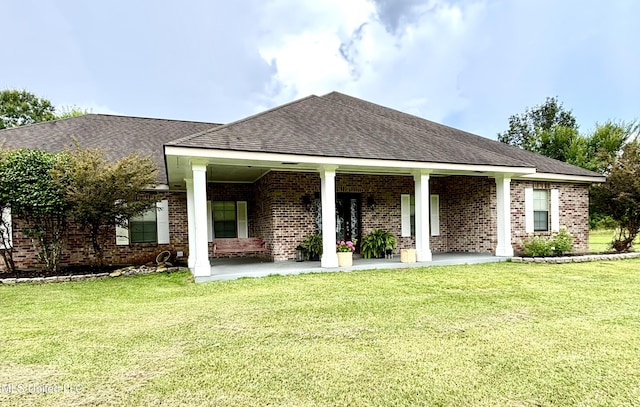 706 Anchor Lake Rd, Carriere, MS 39426 - back of property with a lawn, brick siding, roof with shingles, and covered porch