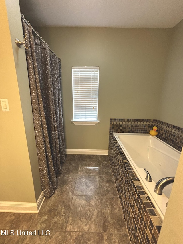 706 Anchor Lake Rd, Carriere, MS 39426 - full bathroom featuring a tub with jets and baseboards