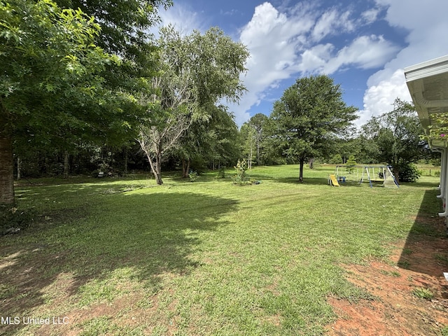 706 Anchor Lake Rd, Carriere, MS 39426 - view of grassy yard with a playground and view of wooded area