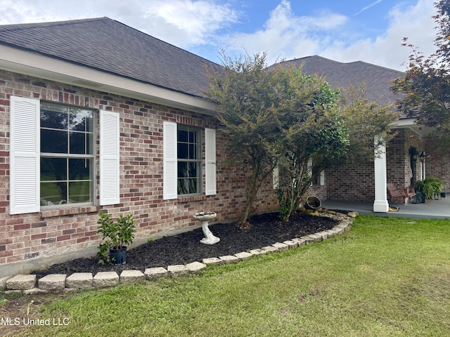 706 Anchor Lake Rd, Carriere, MS 39426 - view of property exterior featuring a shingled roof, brick siding, and a yard