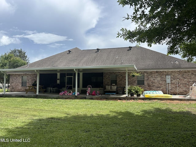 706 Anchor Lake Rd, Carriere, MS 39426 - rear view of property featuring a patio, brick siding, a yard, and a shingled roof
