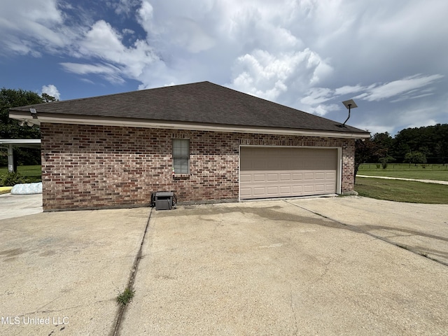 706 Anchor Lake Rd, Carriere, MS 39426 - view of property exterior featuring concrete driveway, brick siding, roof with shingles, and a garage
