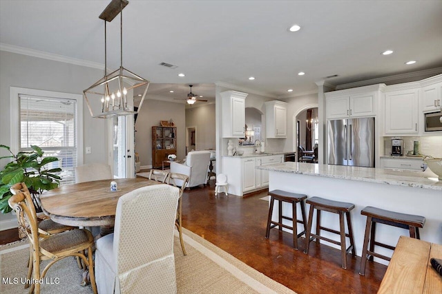 dining area with visible vents, arched walkways, ceiling fan, finished concrete floors, and recessed lighting