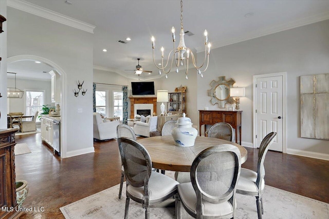 dining space featuring plenty of natural light, a fireplace, and baseboards