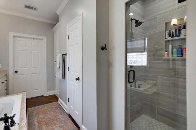 bathroom with visible vents, baseboards, ornamental molding, vanity, and a shower stall