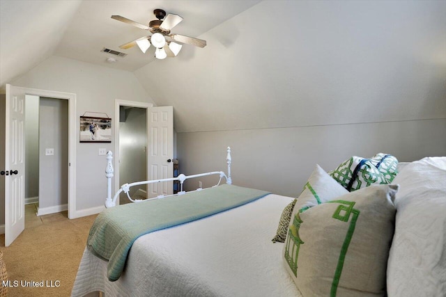 bedroom featuring light colored carpet, visible vents, vaulted ceiling, ceiling fan, and baseboards