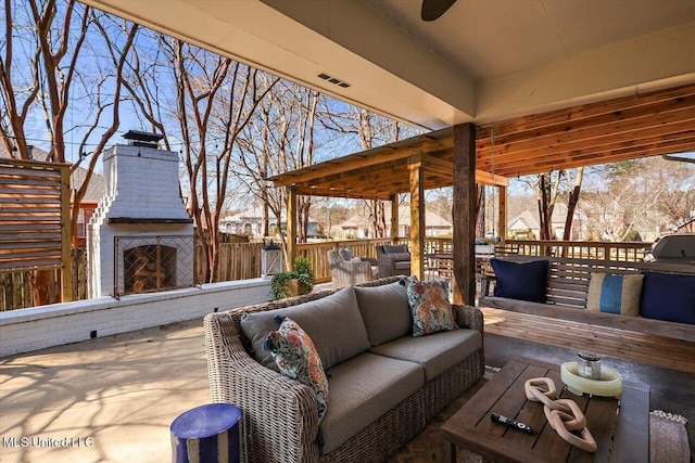 view of patio / terrace with an outdoor living space with a fireplace