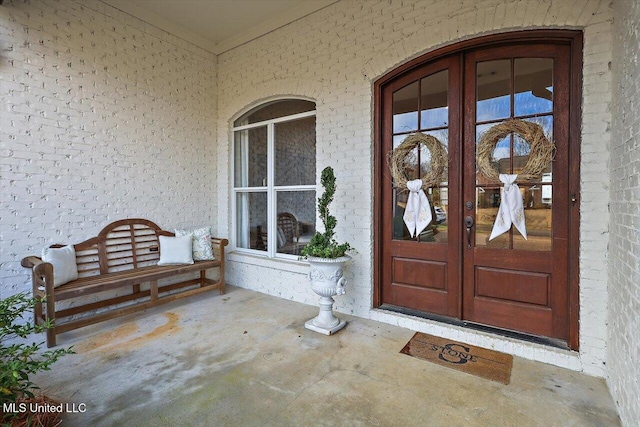 entrance to property featuring french doors and a porch