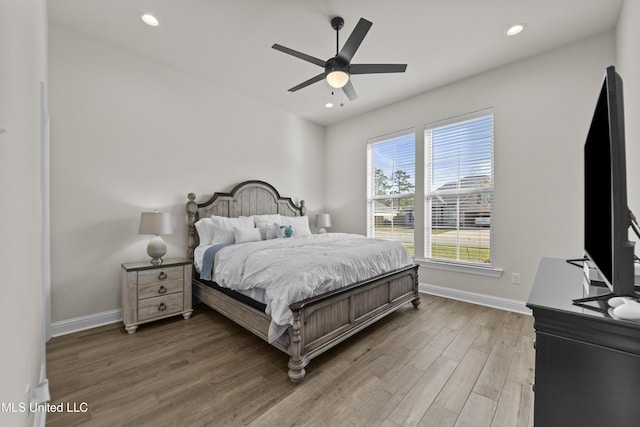 bedroom with a ceiling fan, recessed lighting, baseboards, and wood finished floors