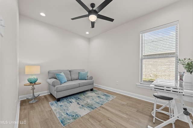 living area featuring a ceiling fan, recessed lighting, baseboards, and wood finished floors