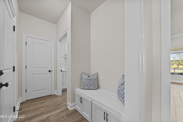 mudroom with light wood-style floors and baseboards