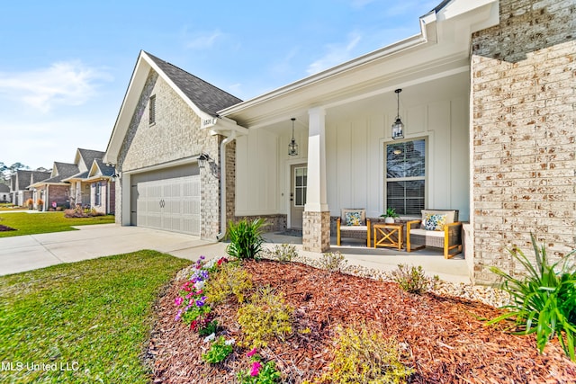 exterior space with concrete driveway, stone siding, an attached garage, covered porch, and board and batten siding