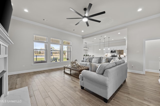 living room with baseboards, visible vents, a fireplace with flush hearth, crown molding, and light wood-type flooring