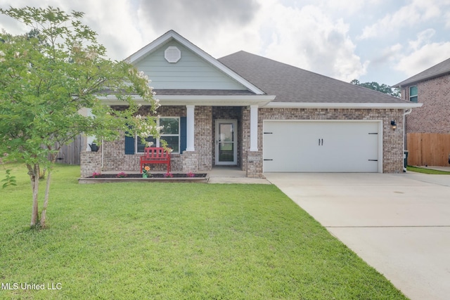 15581 Ollie Ln, Biloxi, MS 39532 - craftsman-style house featuring a garage, driveway, brick siding, covered porch, and a shingled roof