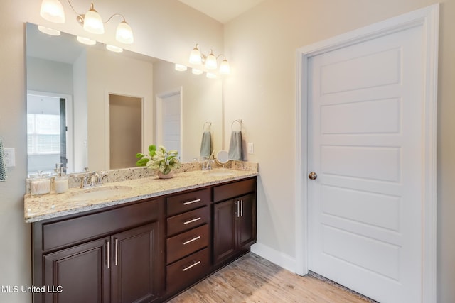 15581 Ollie Ln, Biloxi, MS 39532 - full bath featuring double vanity, wood finished floors, and baseboards